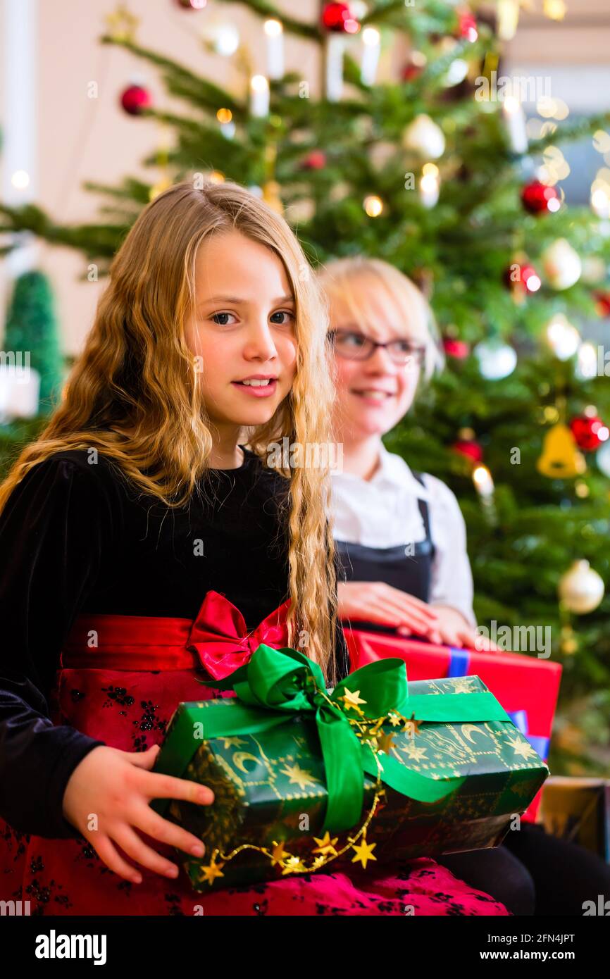 Children with presents and tree on Christmas eve Stock Photo Alamy