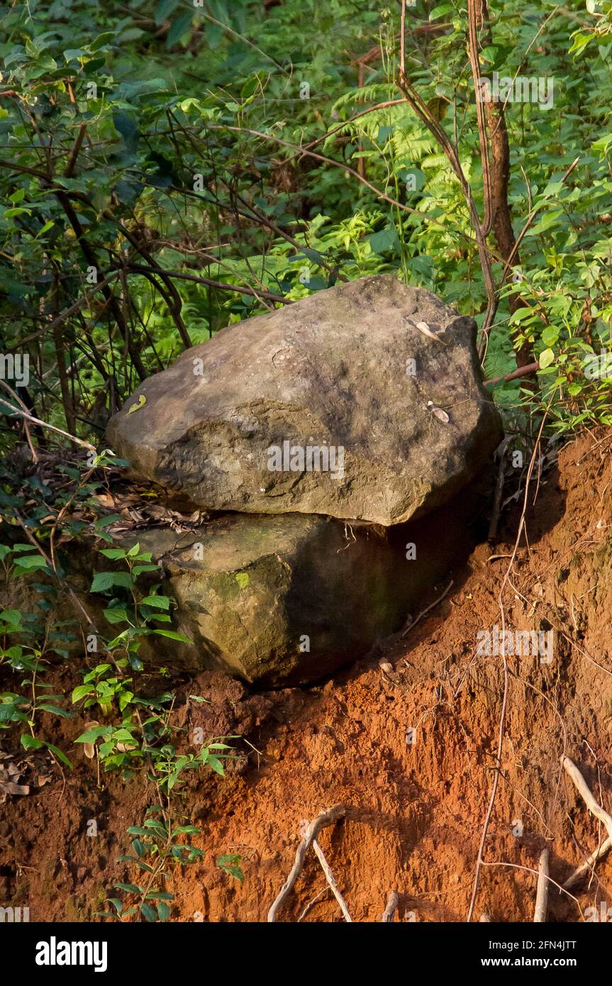 Volcanic basalt boulders balanced precariously after a landslide of unconsolidated ground in