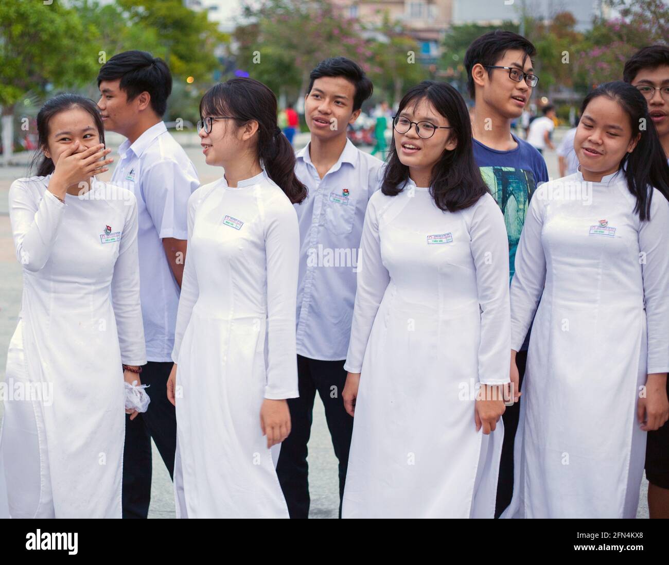 Eight young Vietnamese teenagers rehearsing for drama performance in the park, Da Nang, Vietnam Stock Photo