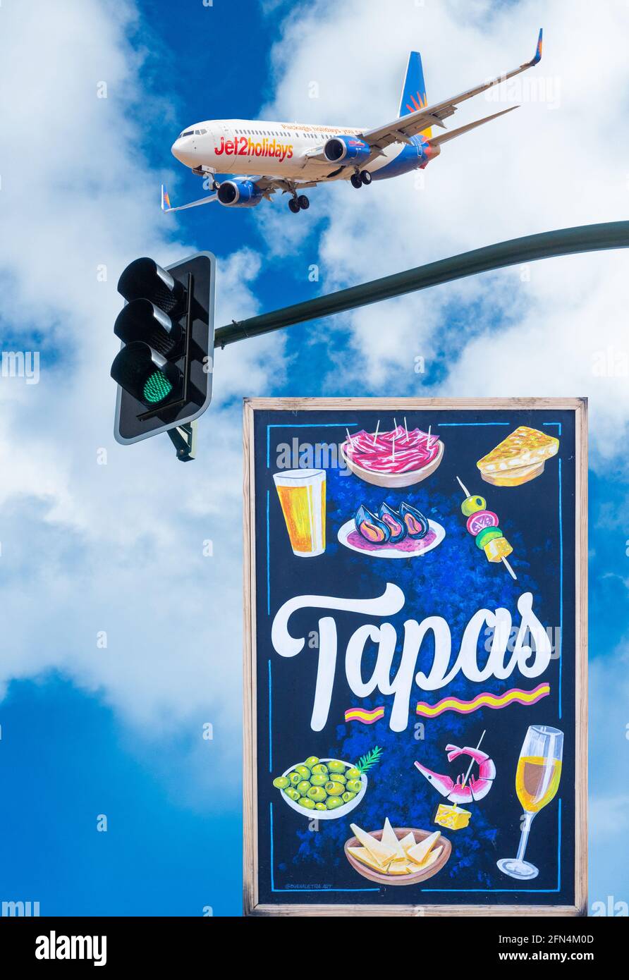 Jet2 airplane above green traffic light and Tapas sign: Spain, Covid, Coronavirus, aviation industry, travel, tourism... concept Stock Photo
