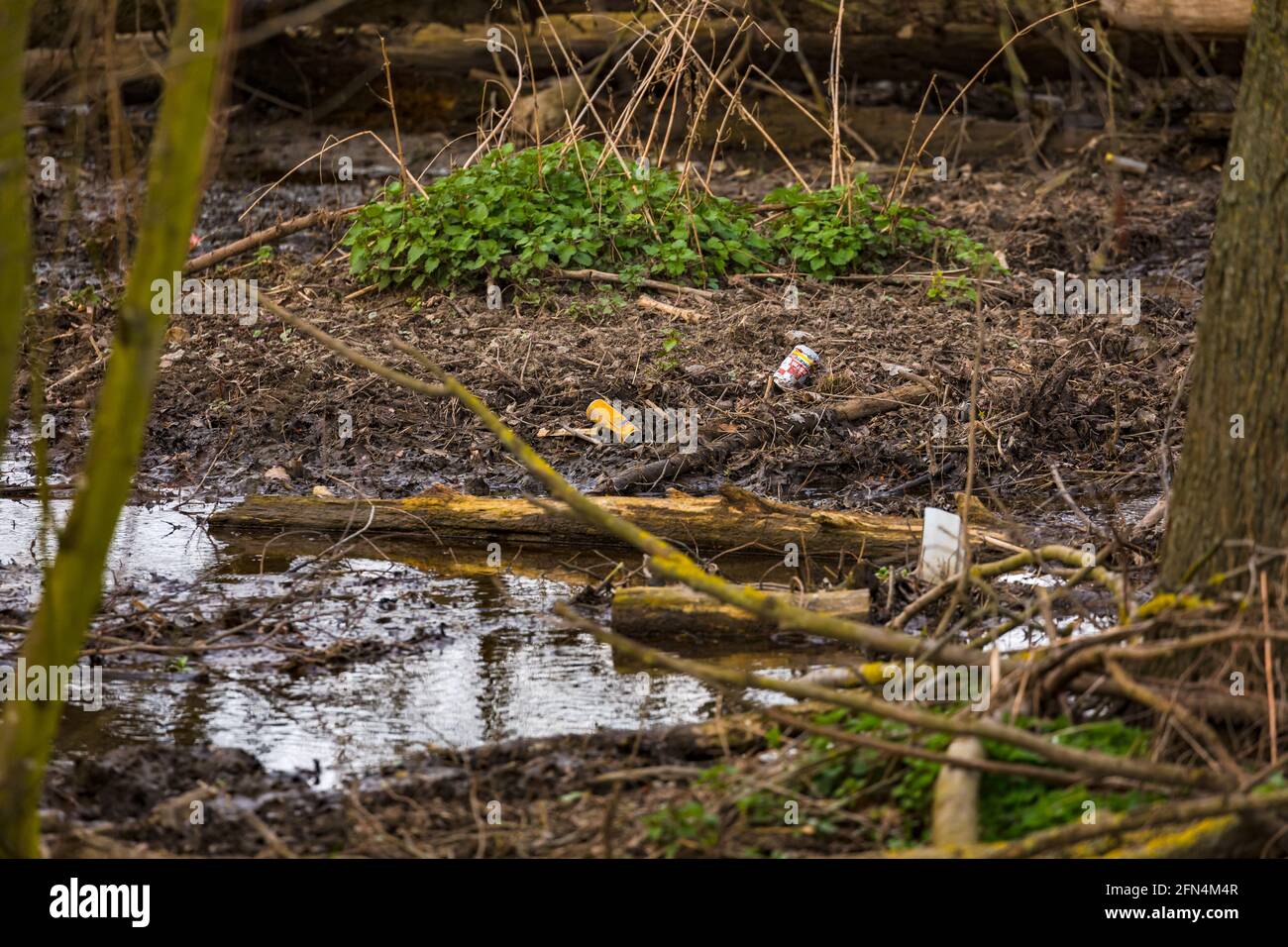 Plastic and soda cans pollute a small river Stock Photo