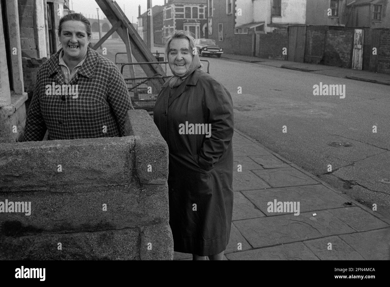 Two ladies on outside a house in Splott, Cardiff, 1973 Stock Photo