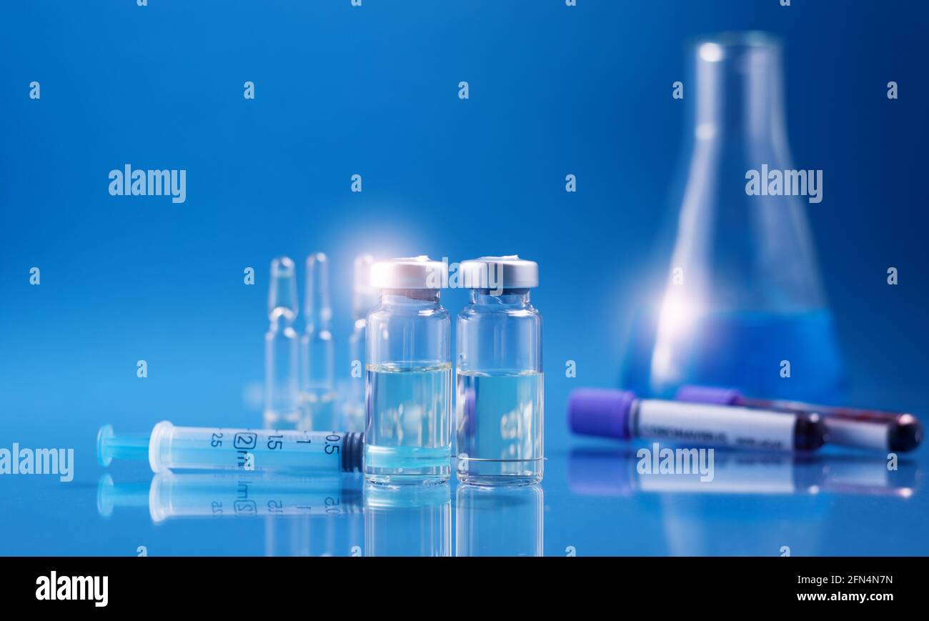 Glass ampoules with liquid for injection against laboratory flasks on