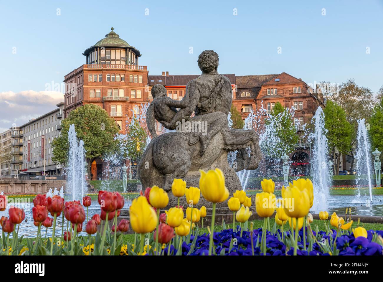 Mannheim Rosengarten formal garden is an absolute beautiful place in city. People gather there to have picnics and hang around with friends. Stock Photo