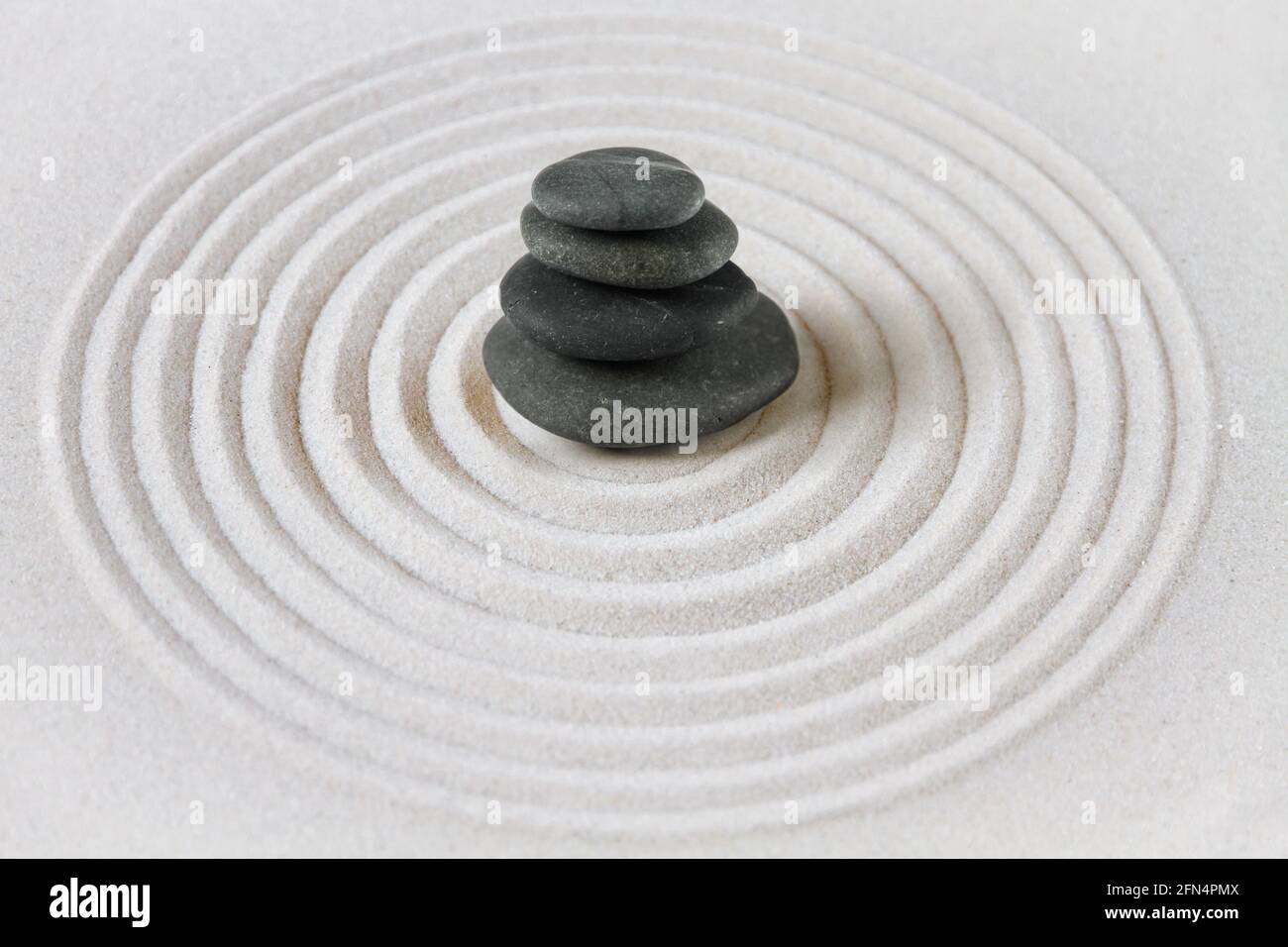 Black stones pile in the sand. Zen japanese garden background scene ...