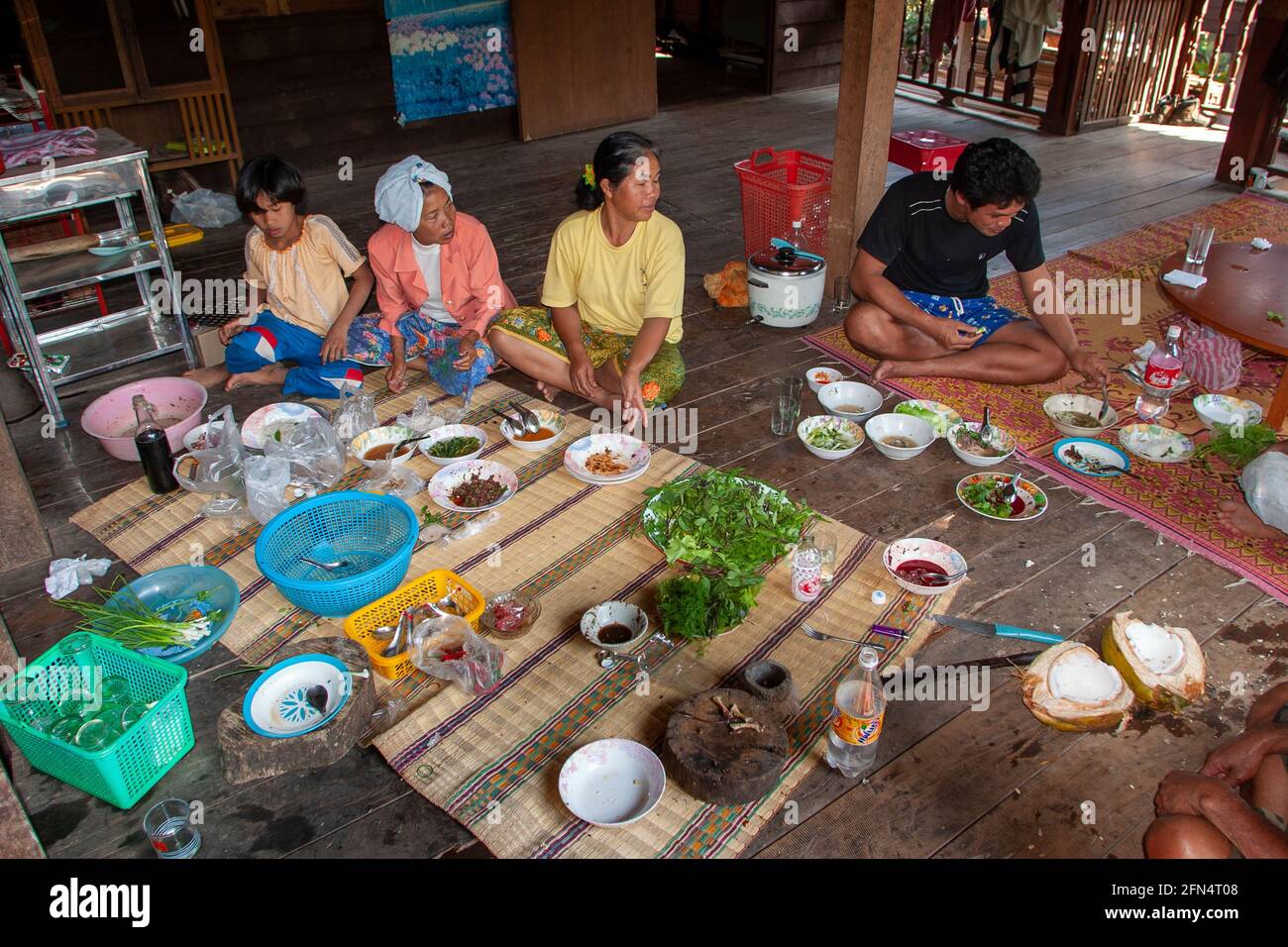 Traditional rural Thai meal the family sits on mats on the floor Stock