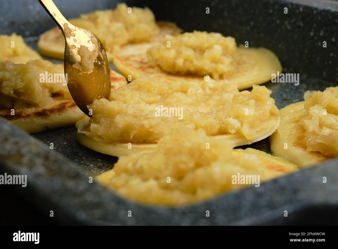 Closeup view of pancakes with caramelized apple and coconut cream (photo with shallow depth of field) Stock Photo