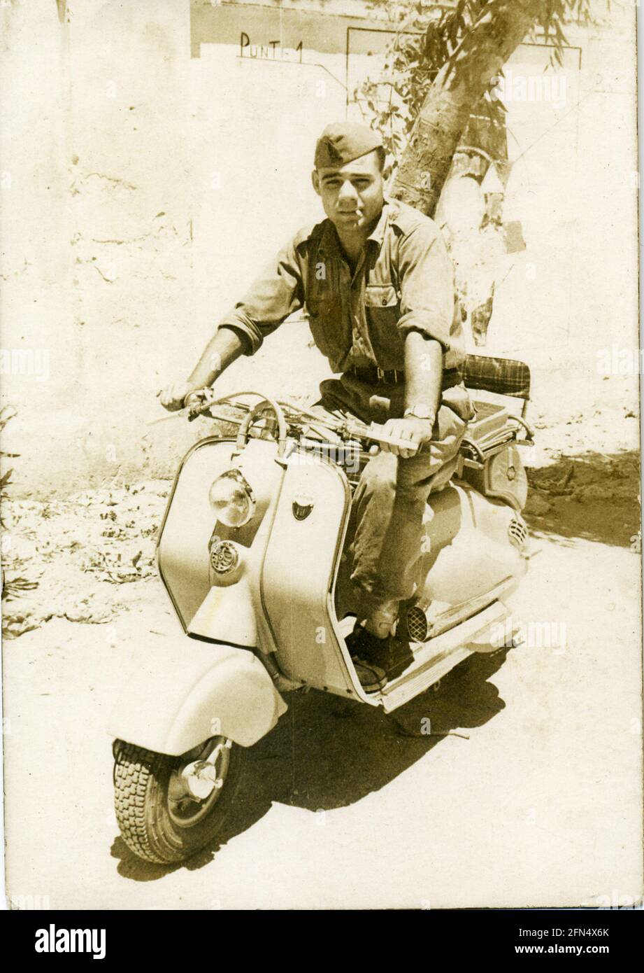 Archive image: Italian soldier on Lambretta LD 150 - Innocenti scooter - 1950's Stock Photo