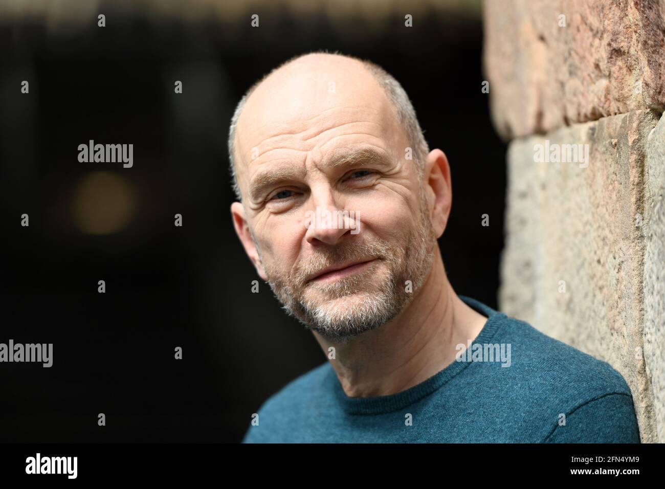 Bad Hersfeld, Germany. 14th May, 2021. Götz Schubert (Keating in "Dead Poets Society") leans against a wall in the Stfitsruine. The Bad Hersfeld Festival is to open on 1 July with a stage version of the Hollywood film "Dead Poets Society". Credit: Uwe Zucchi/dpa/Alamy Live News Stock Photo