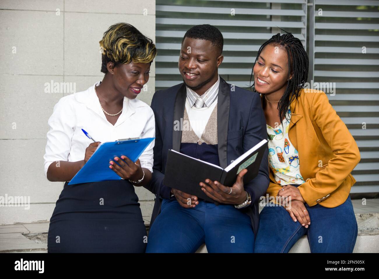 young assistant woman sitting taking notes for her boss smiling Stock ...