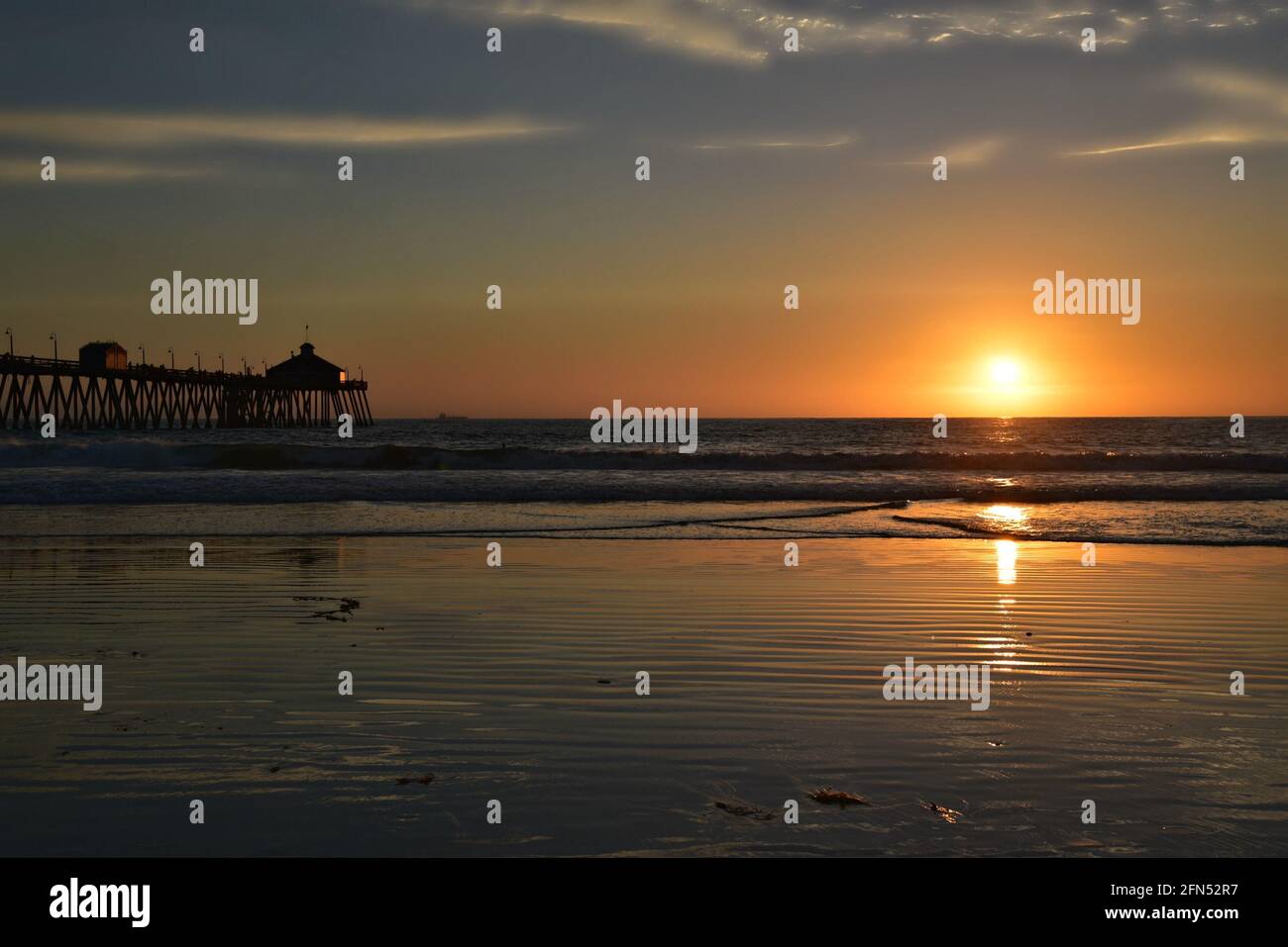 Sunset seascape with panoramic view of Imperial Beach Pier and the Tin Fish Restaurant in San Diego, California USA. Stock Photo