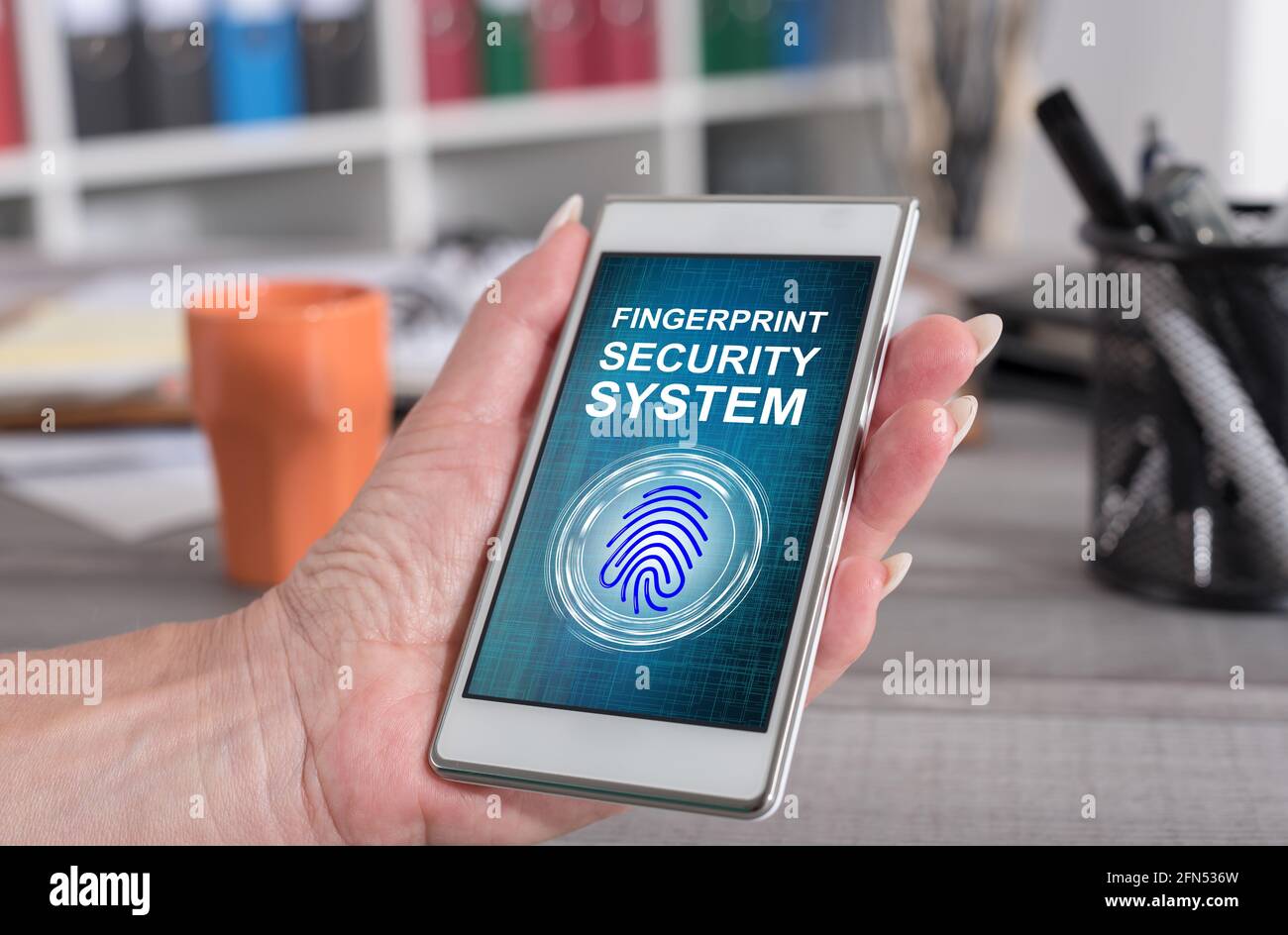 Female hand holding a smartphone with fingerprint security system ...