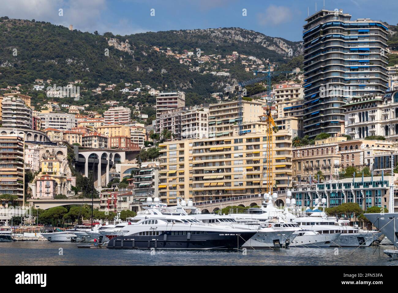 Hillsides and buildings bordering the yacht and boat marina at Monte Carlo, Monaco on the French Riviera. Stock Photo