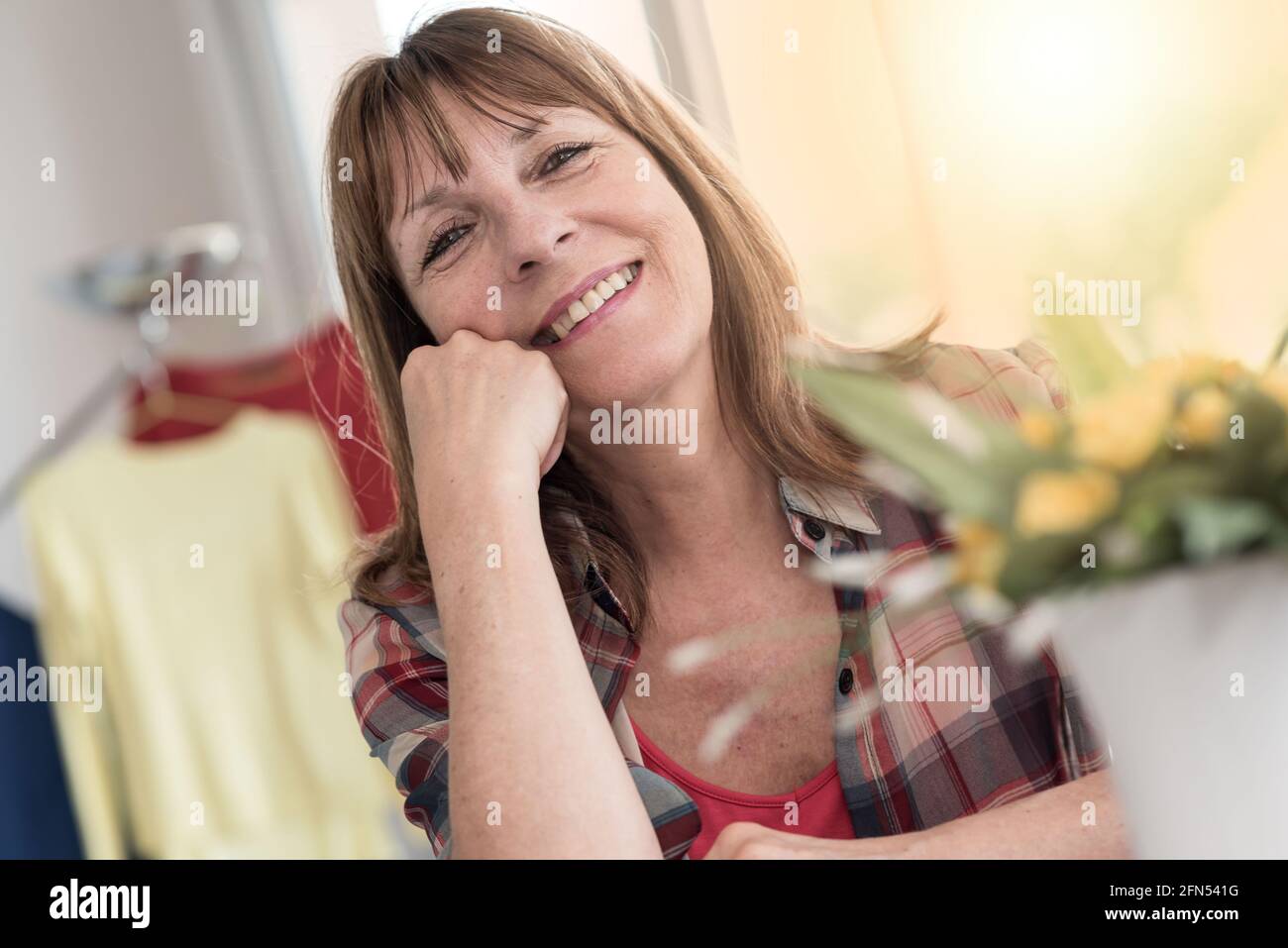Portrait of smiling mature woman at home, light effect Stock Photo - Alamy