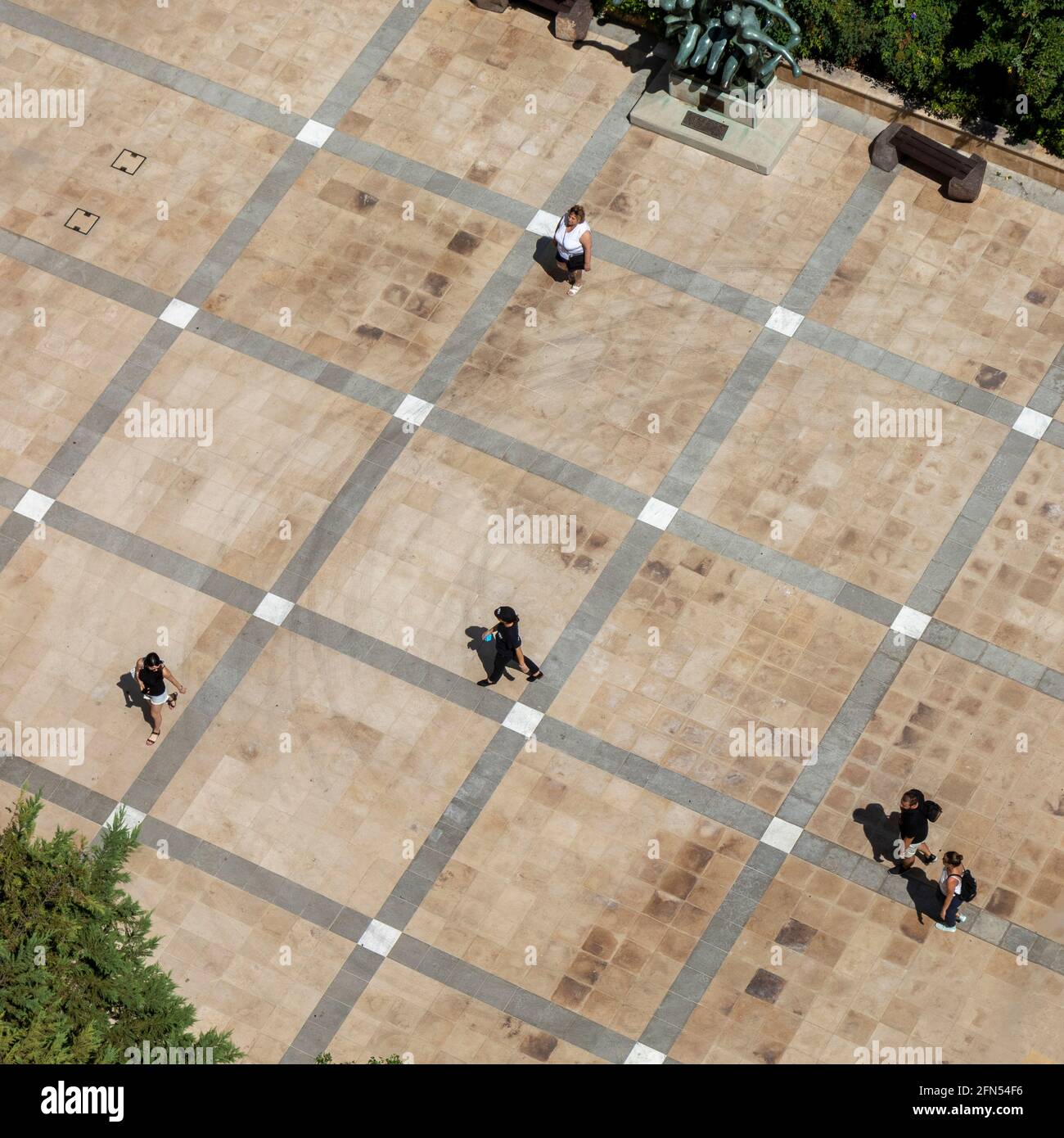 Overlooking a patio square intersection with tourists walking in the sunlight. Monte Carlo, Monaco. Stock Photo