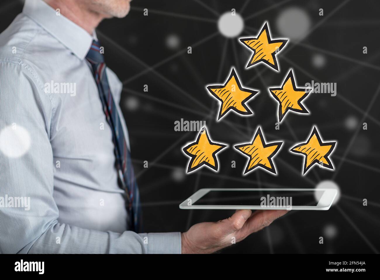 Quality concept above a tablet held by a man Stock Photo