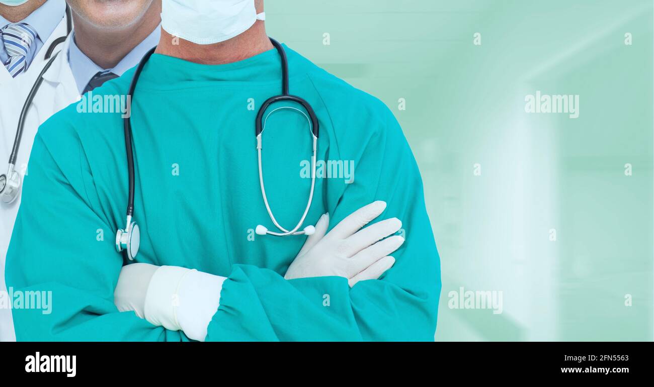 Mid section of team of medical professionals against hospital in background Stock Photo