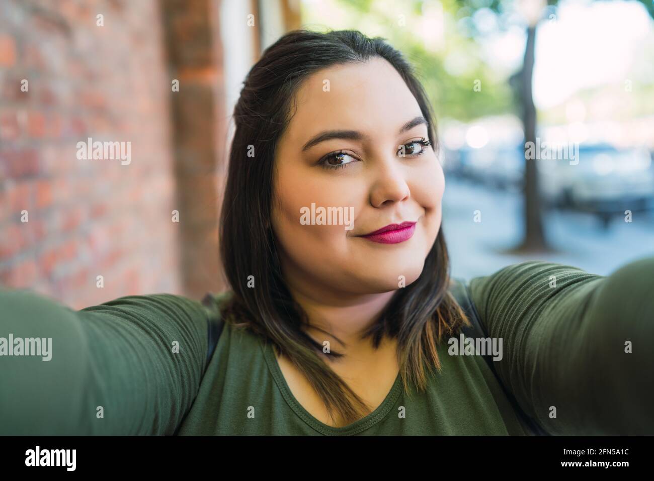 Young plus size woman taking a selfie Stock Photo - Alamy