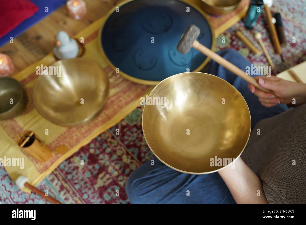 Caucasian woman holding a Tibetan singing bowl in her hand for sound