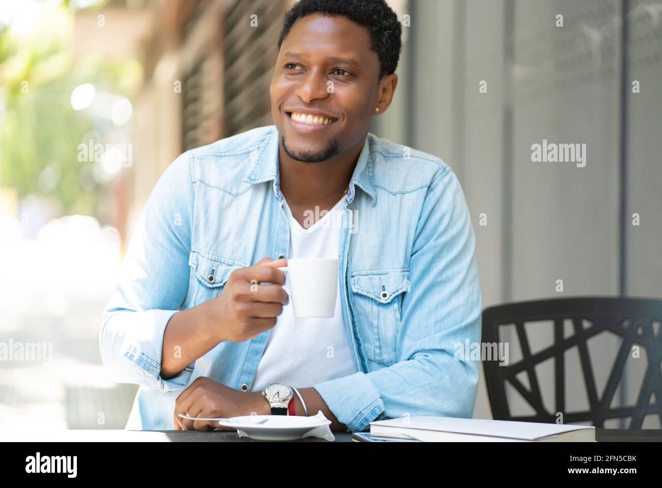 Man drinking coffee at coffee shop Stock Photo - Alamy