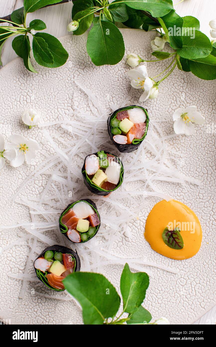 Top view of healthy Japanese sushi roll without rice with crab meat wrapped in daikon radish