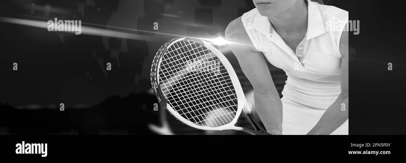Composition of midsection of woman playing tennis in black and white Stock Photo