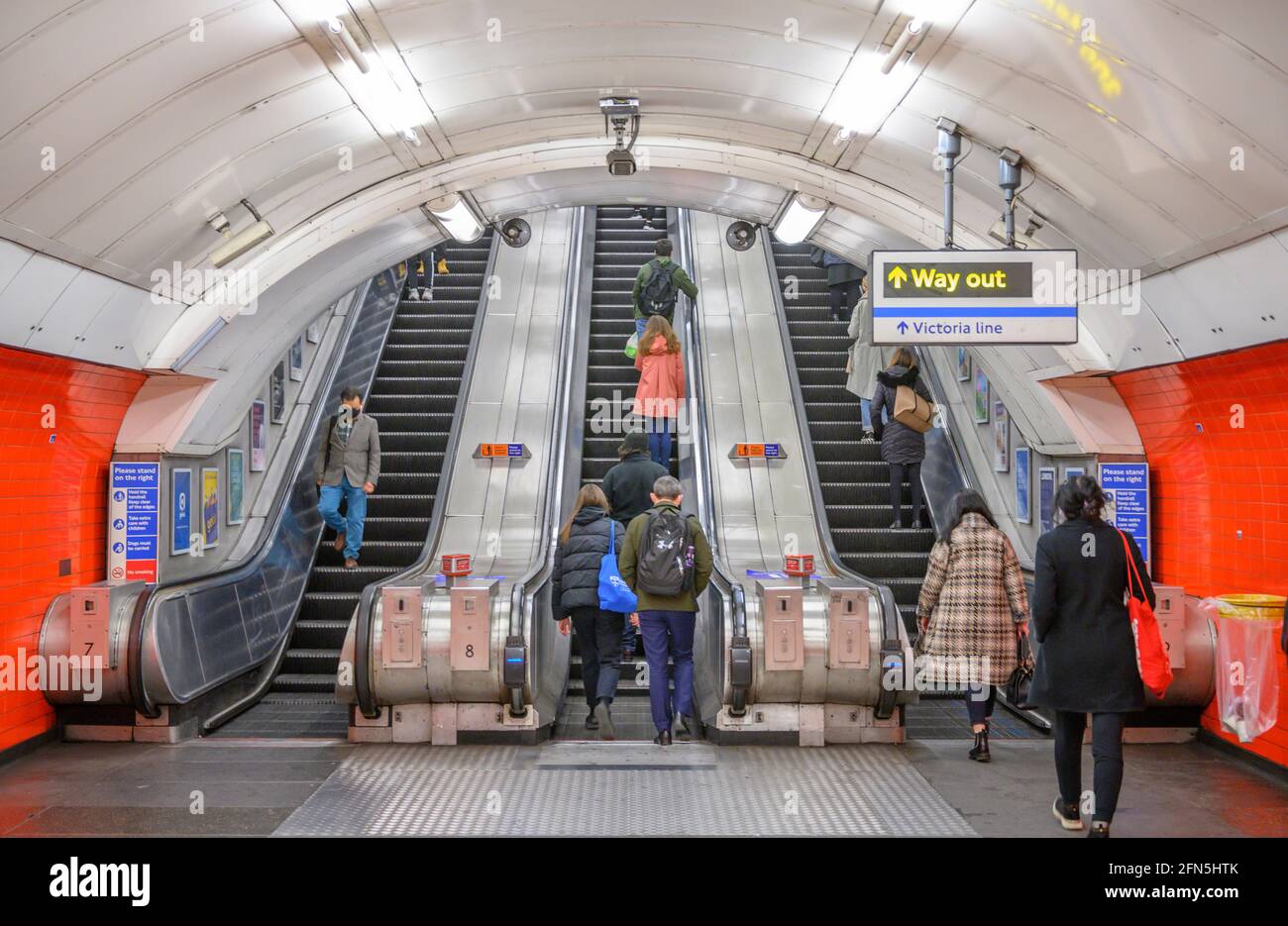 Oxford Street, London, UK. 14th May, 2021. More shoppers venturing into  central London as the capital opens up major galleries and museums from  18th May. Image: Shoppers using the escalators at Oxford