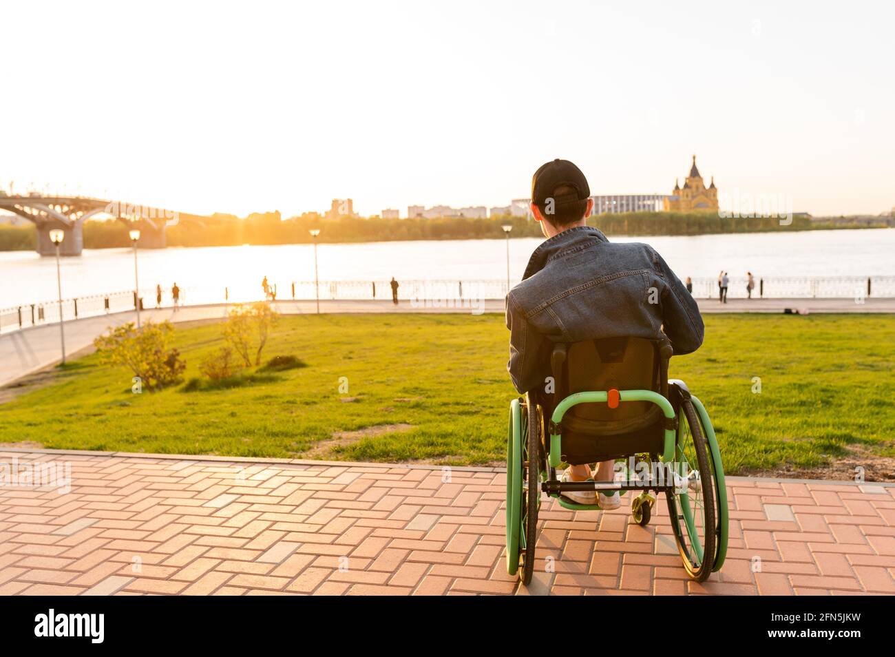 disabled young guy in a wheelchair. Disabled person in a wheelchair for