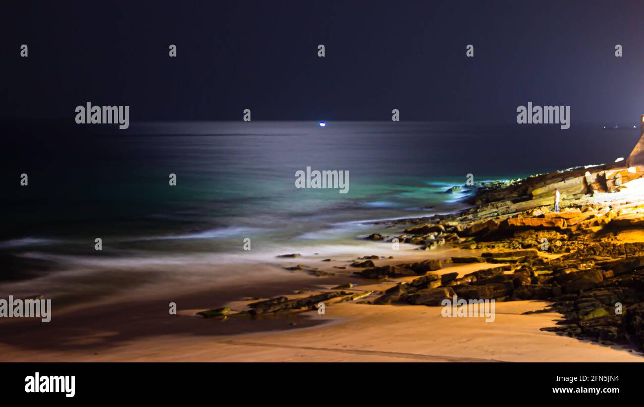 Seascape by night and moonlght reflection in the middle of the sea in Taghazout Beach Stock Photo
