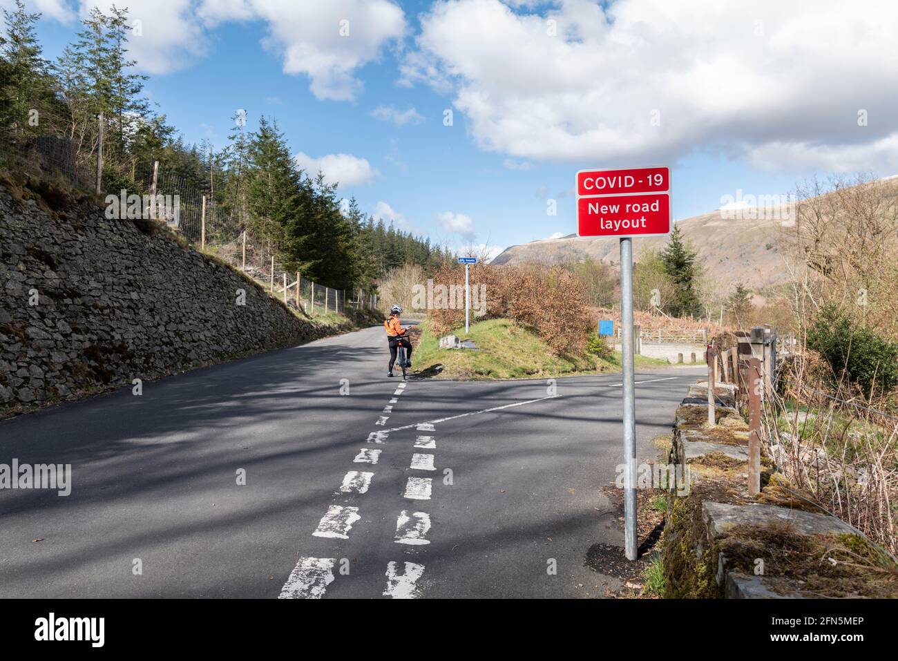 Covid 19 sign warning of new road layout at Thirlmere dam, Lake District, UK. Stock Photo