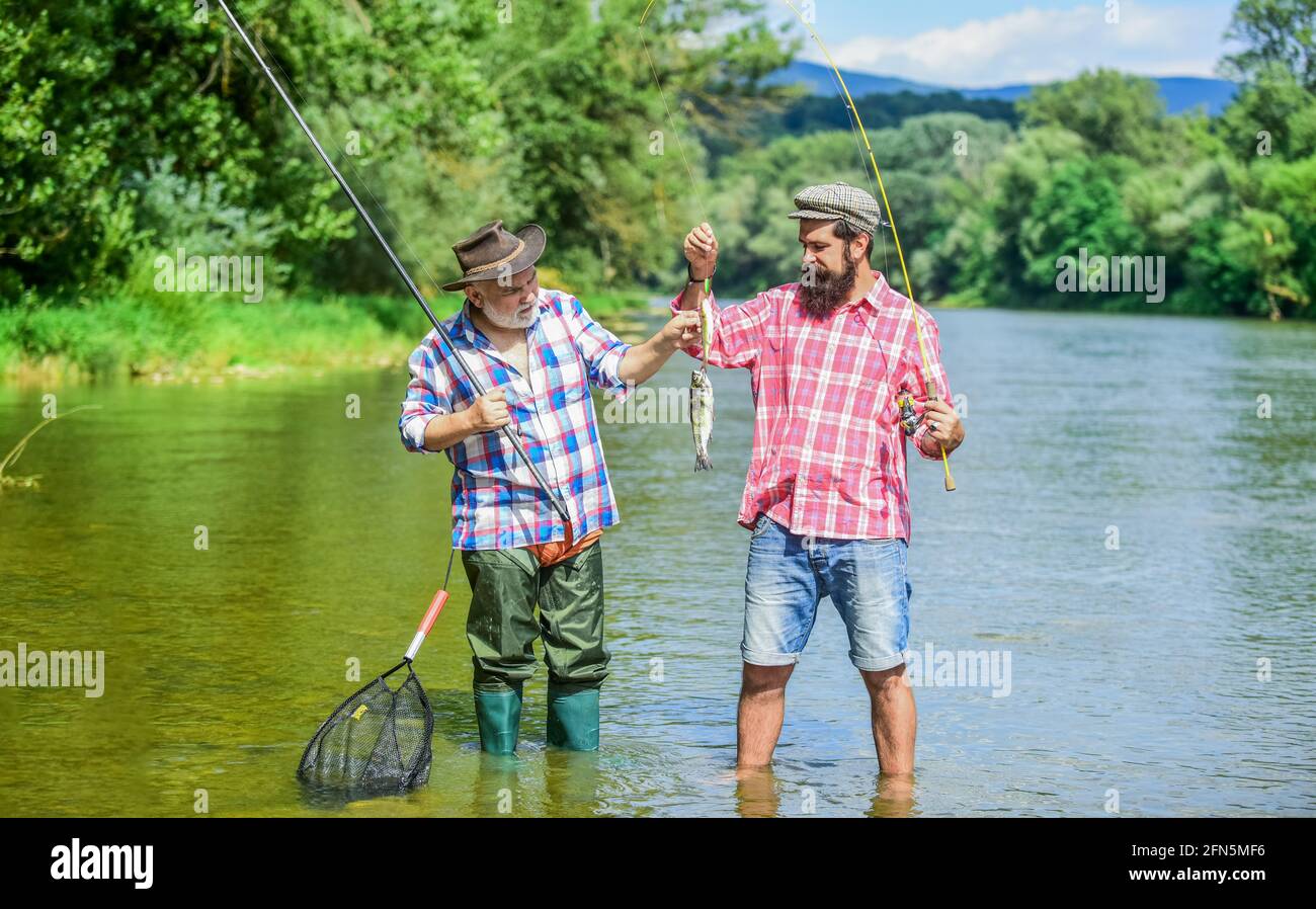 Mature man with friend fishing. It is not sport, it is obsession