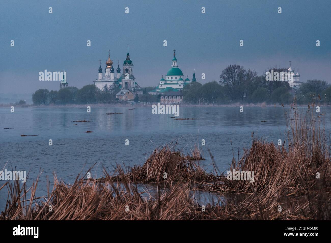 View of Spaso-Yakovlevsky Monastery in Rostov Veliky from Nero's lake on a sunset Stock Photo