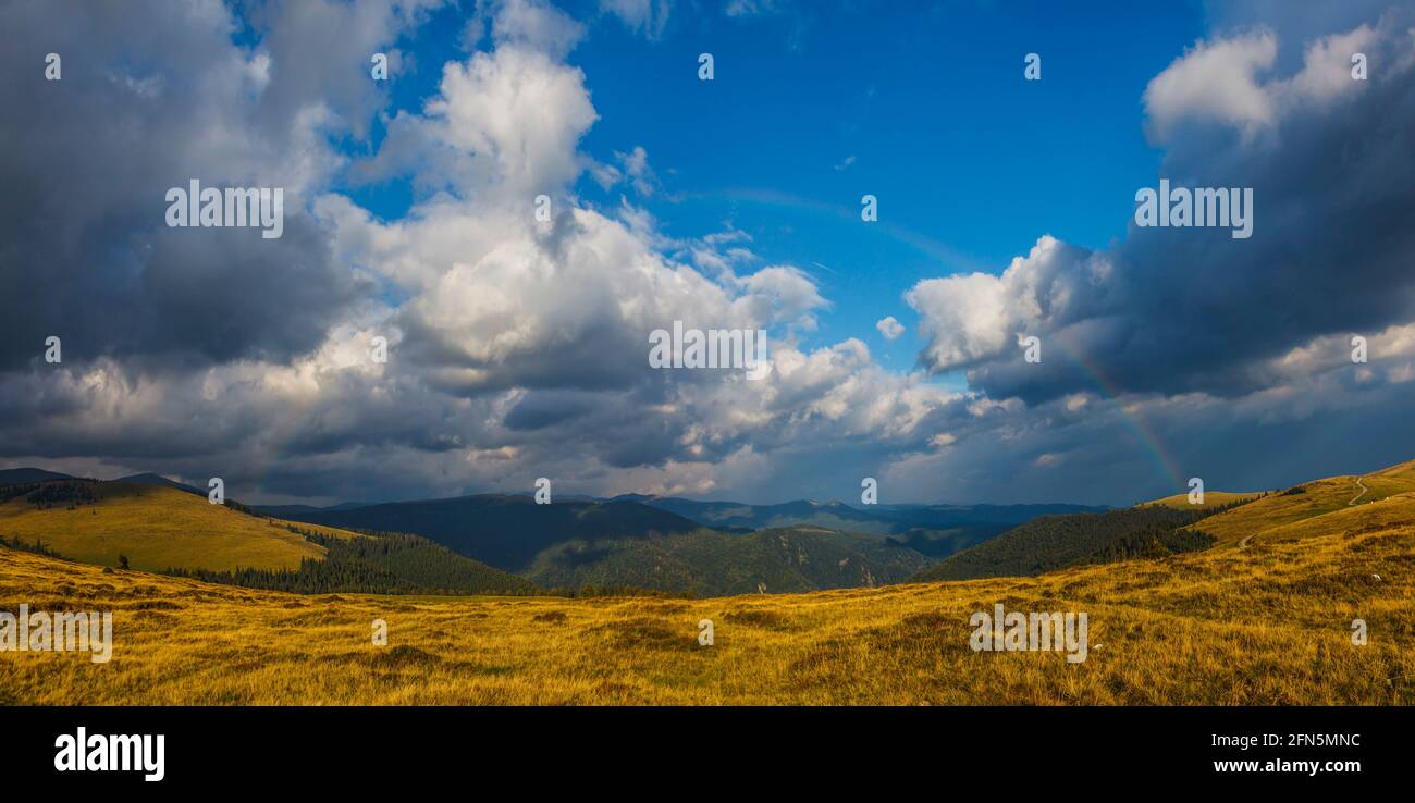 Panoramic view of Parang Mountains, rainbow, extreme weather, Ranca resort, Novaci, famous high altitude Transalpina road, Gorj County, Romania Stock Photo