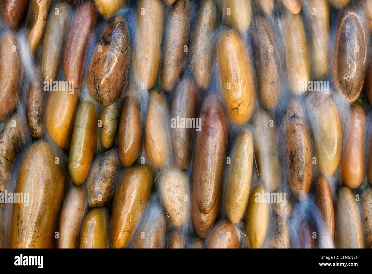 Waterfalls over rocks in rock waterfall garden. Stock Photo