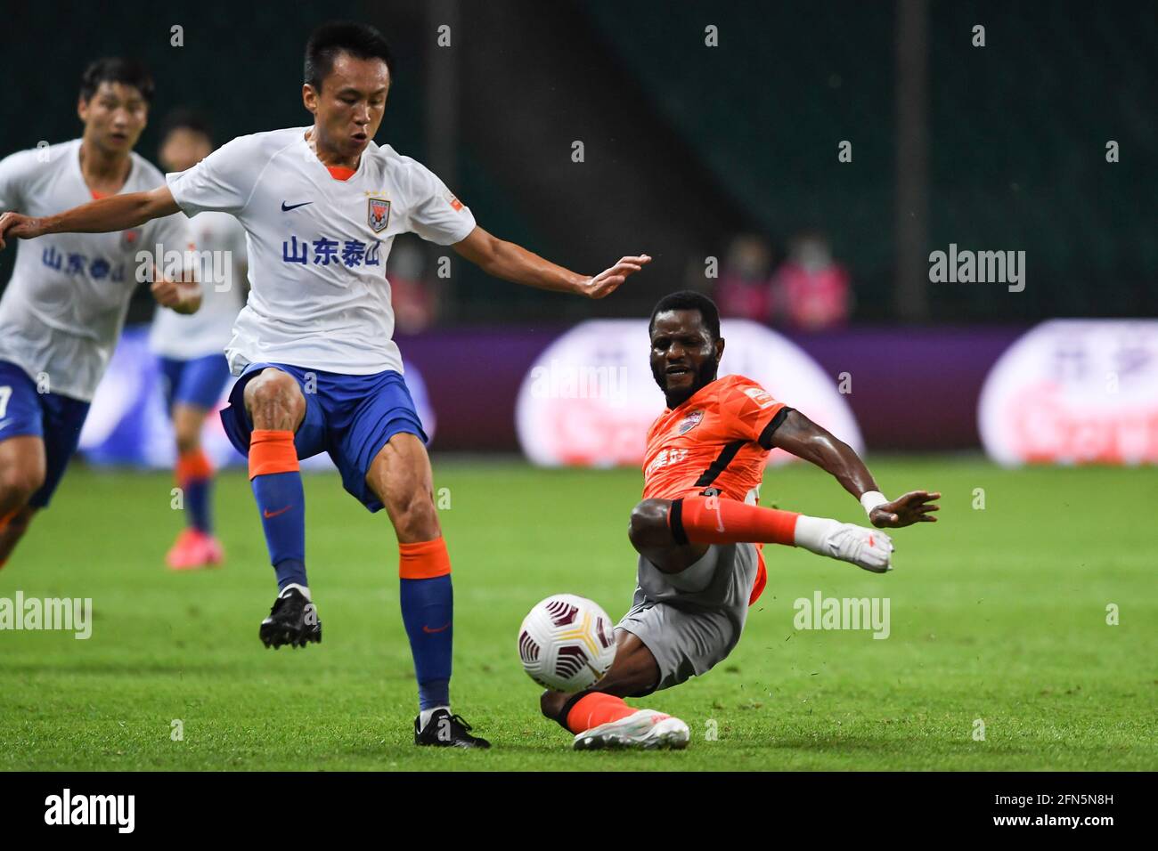 Guangzhou. 14th May, 2021. Mubarak Wakaso (R) of Shenzhen FC competes during the 5th round match between Shenzhen FC and Shandong Taishan at the 2021 season Chinese Football Association Super League (CSL) Guangzhou Division in Guangzhou, south China's Guangdong Province, May 14, 2021. Credit: Xinhua/Alamy Live News Stock Photo