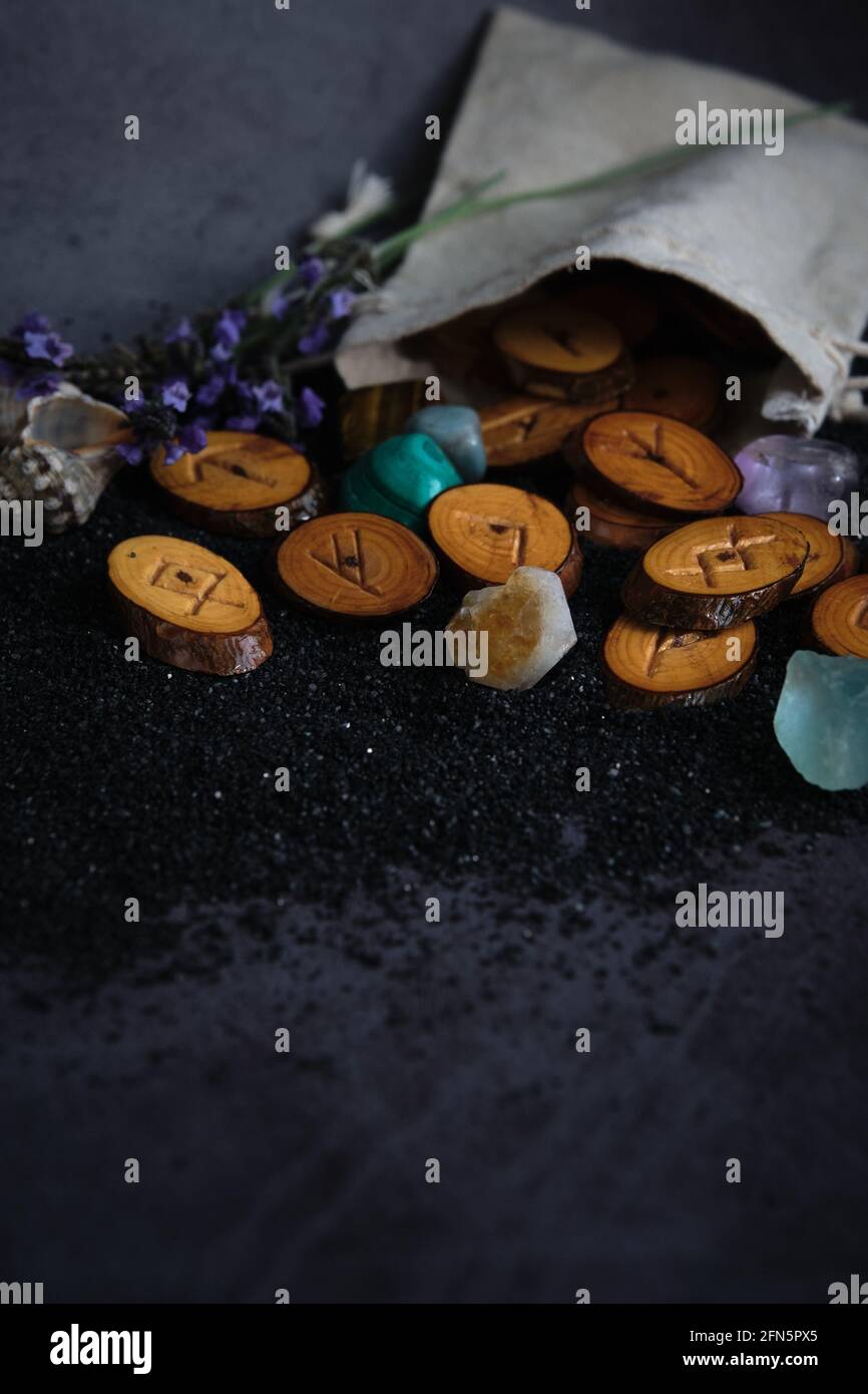 homemade wooden runes on a dark background Stock Photo - Alamy