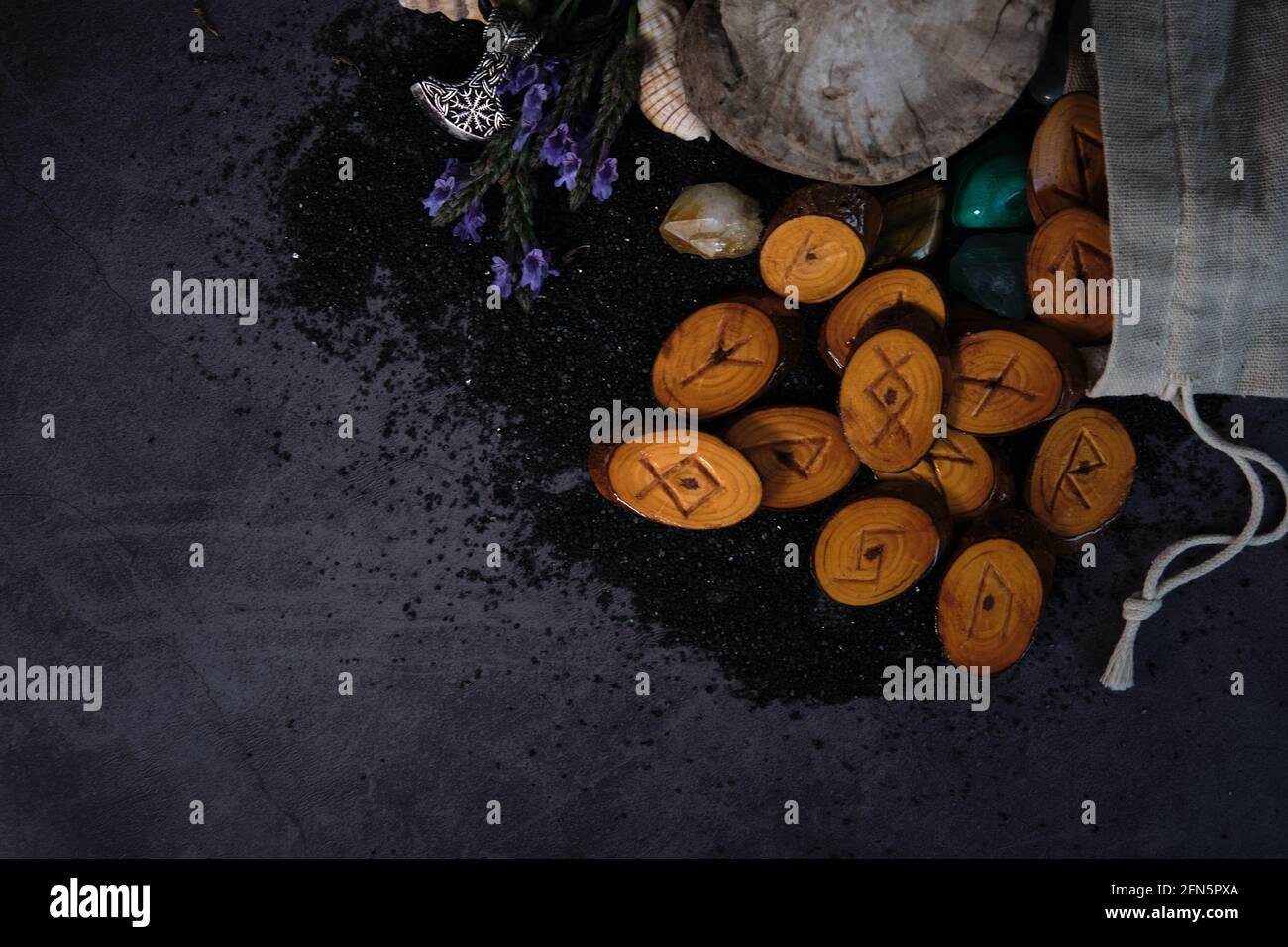 homemade wooden runes on a dark background Stock Photo - Alamy