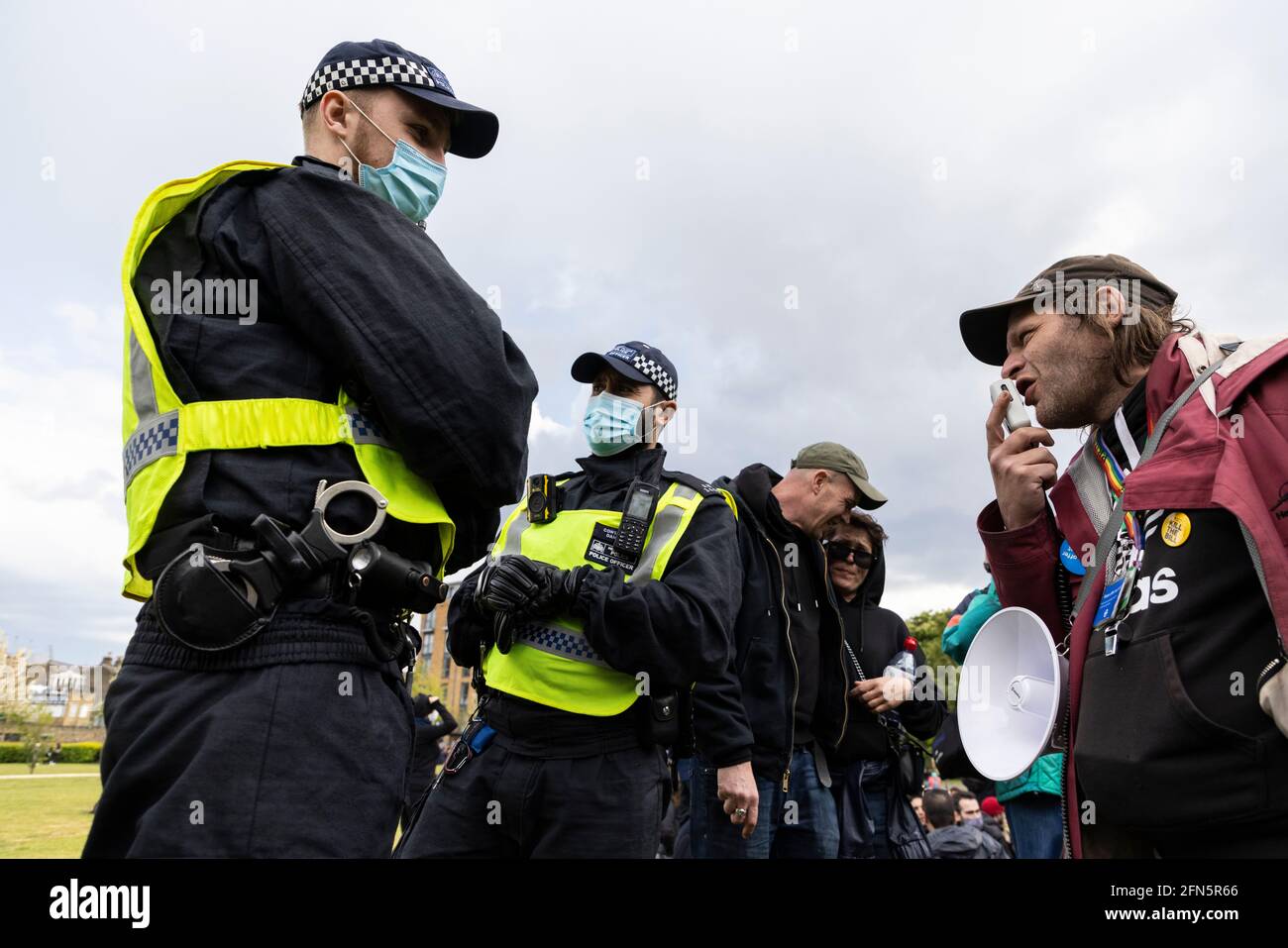 Protester with megaphone confronts police at a 'Kill the Bill' protest against new policing bill, London, 1 May 2021 Stock Photo