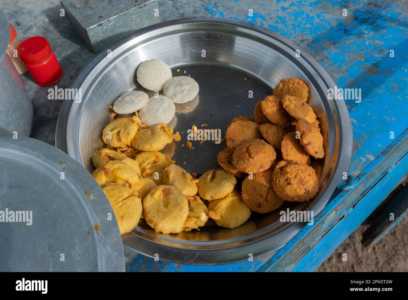 Piiyaji, bara, aloo chop etc, are being sold by cart puller called thelawalla , street foods of Odisha. Stock Photo