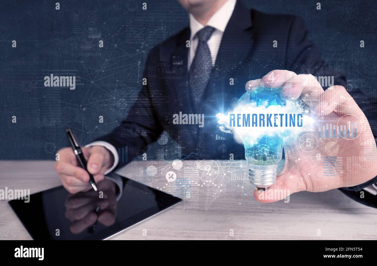 Businessman holding a light bulb, business concept Stock Photo - Alamy
