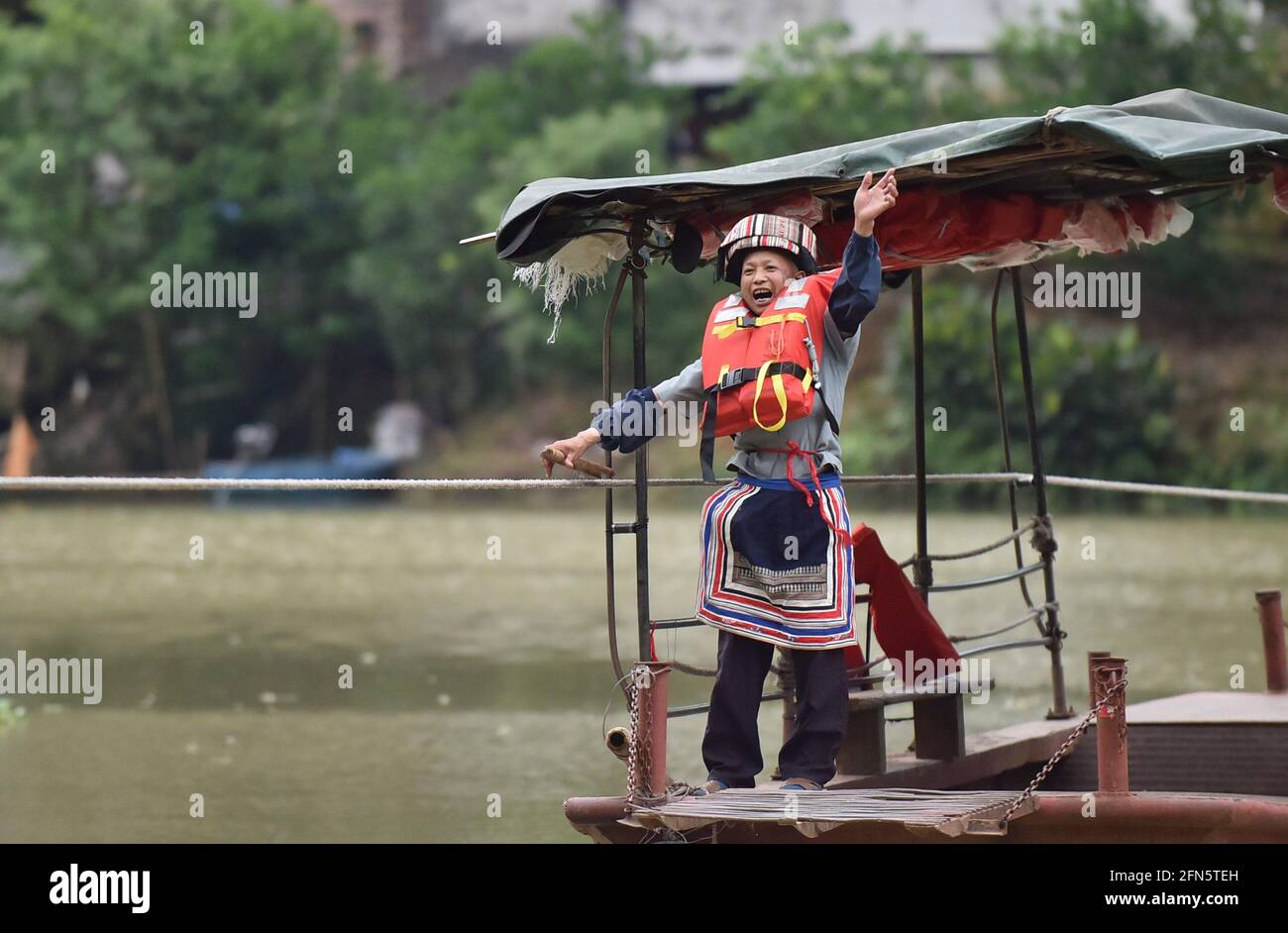 210514 Hezhou May 14 2021 Xinhua Zhao Shibin Greets Students Who Wait To Board A Boat In Huangdong Yao Township Of Hezhou City South China S Guangxi Zhuang Autonomous Region May