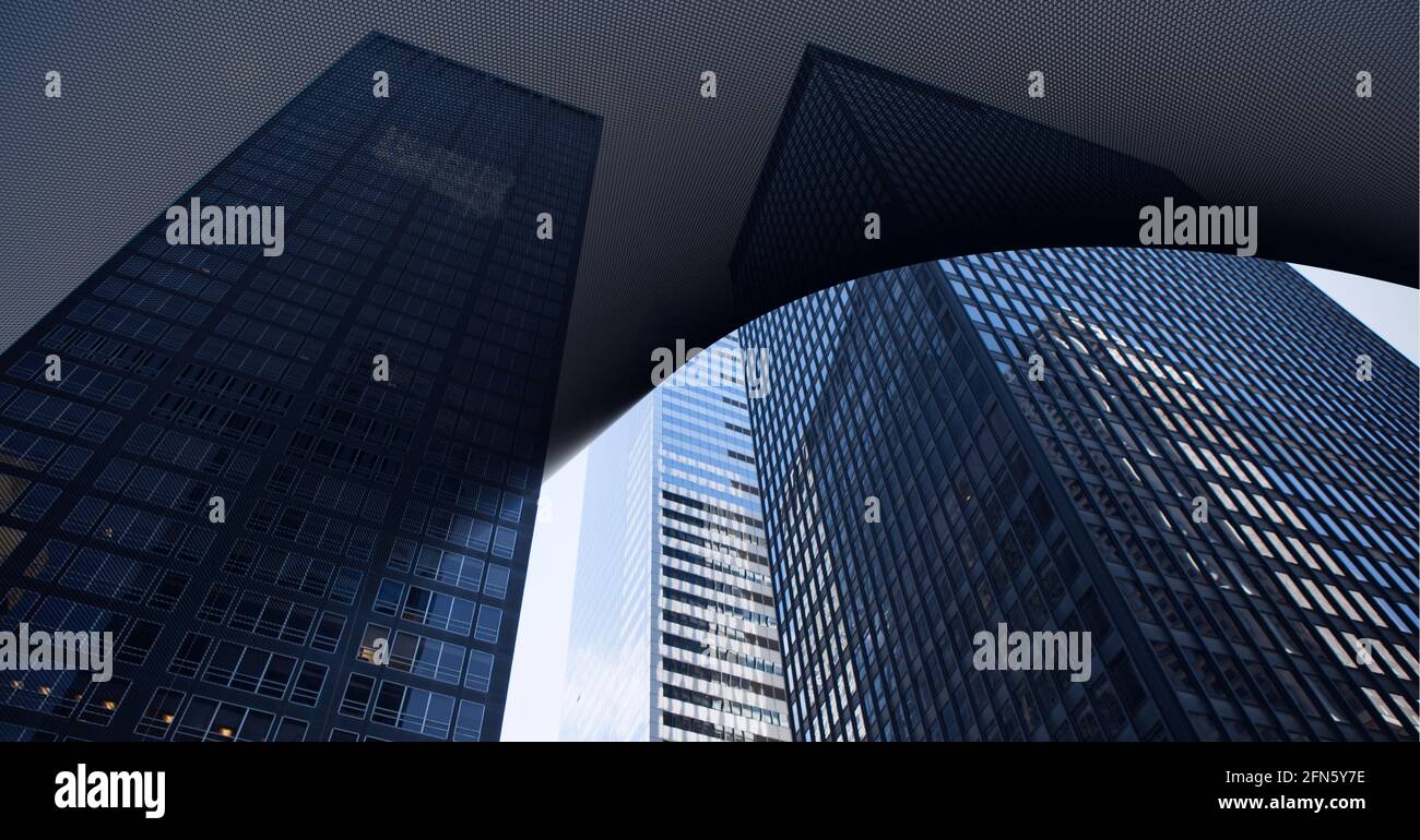 Digital composite image of abstract black geometrical shapes against tall buildings in background Stock Photo