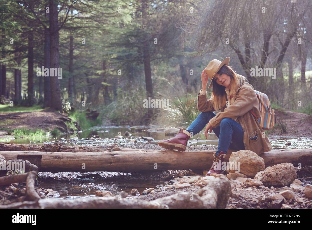 Woman on the mountain. She is in a forest with pine trees Stock Photo ...