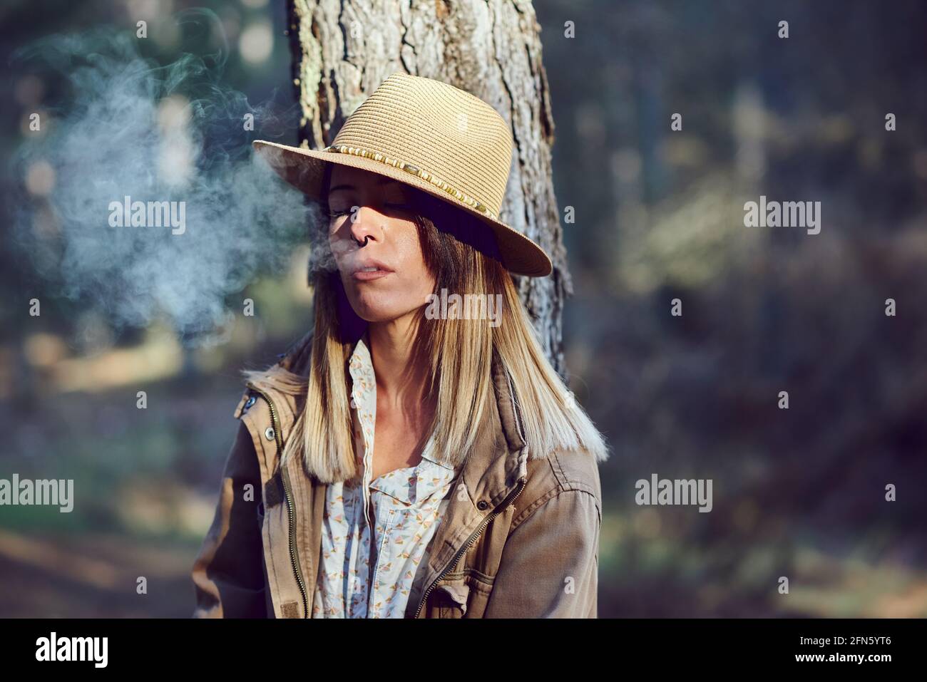 Woman on the mountain. She is in a forest with pine trees Stock Photo ...