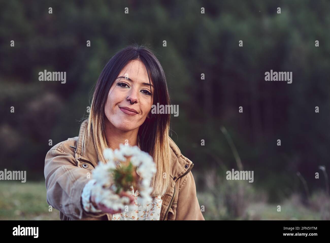 Woman on the mountain. She is in a forest with pine trees Stock Photo ...
