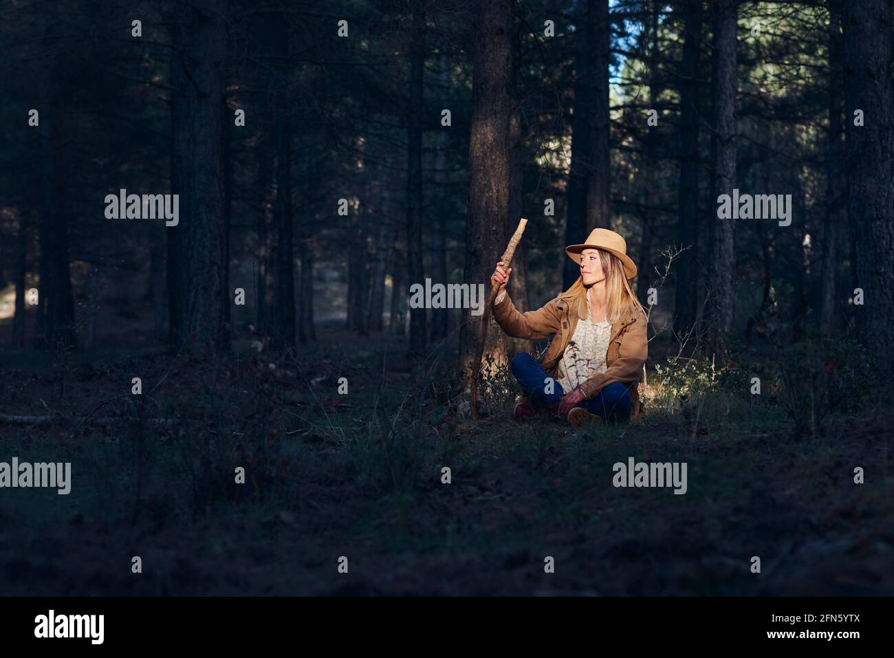 Woman on the mountain. She is in a forest with pine trees Stock Photo ...