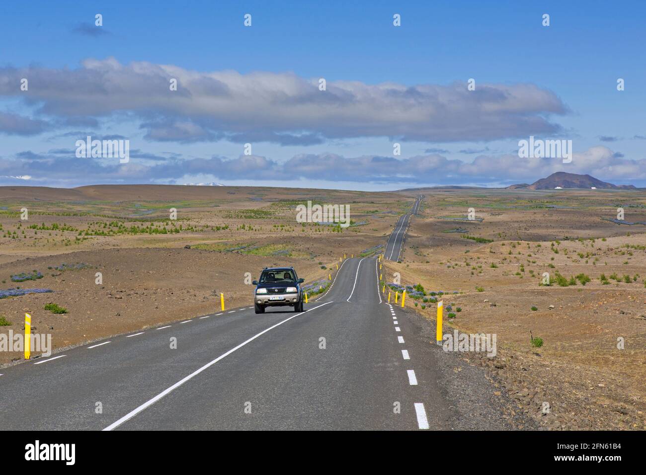 Lonely car driving the Highway 85 / Norðausturvegur / Route 85 in summer, primary road in Nordurland eystra, northeastern Iceland Stock Photo