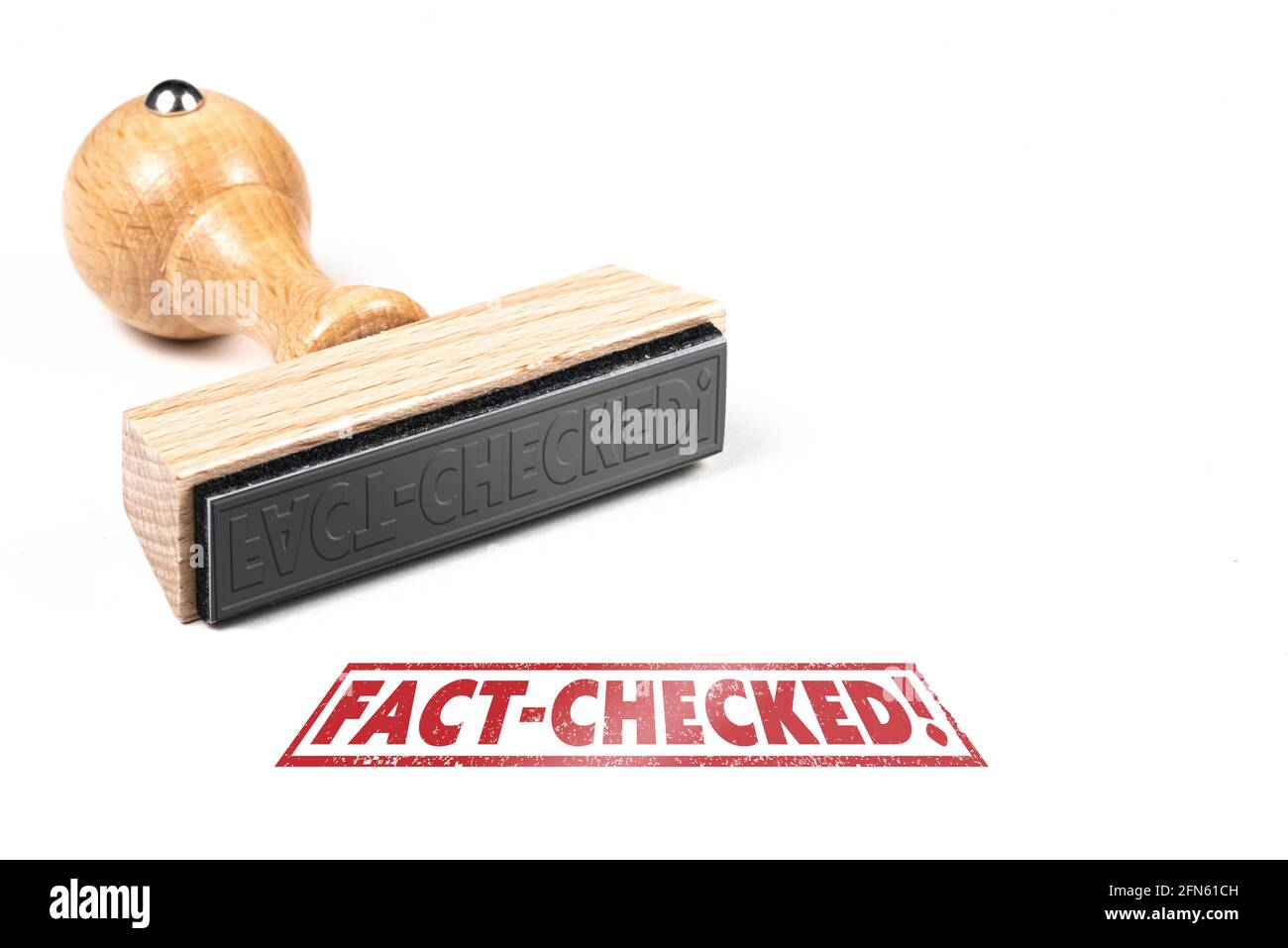 wooden rubber stamp and imprint with text FACT-CHECKED on white background Stock Photo