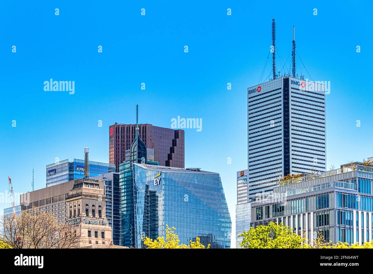 Zoom to the skyscrapers in the downtown district in Toronto, Canada. Logos of BMO, Scotiabank, KPMG, and EY are seen on top of the buildings Stock Photo