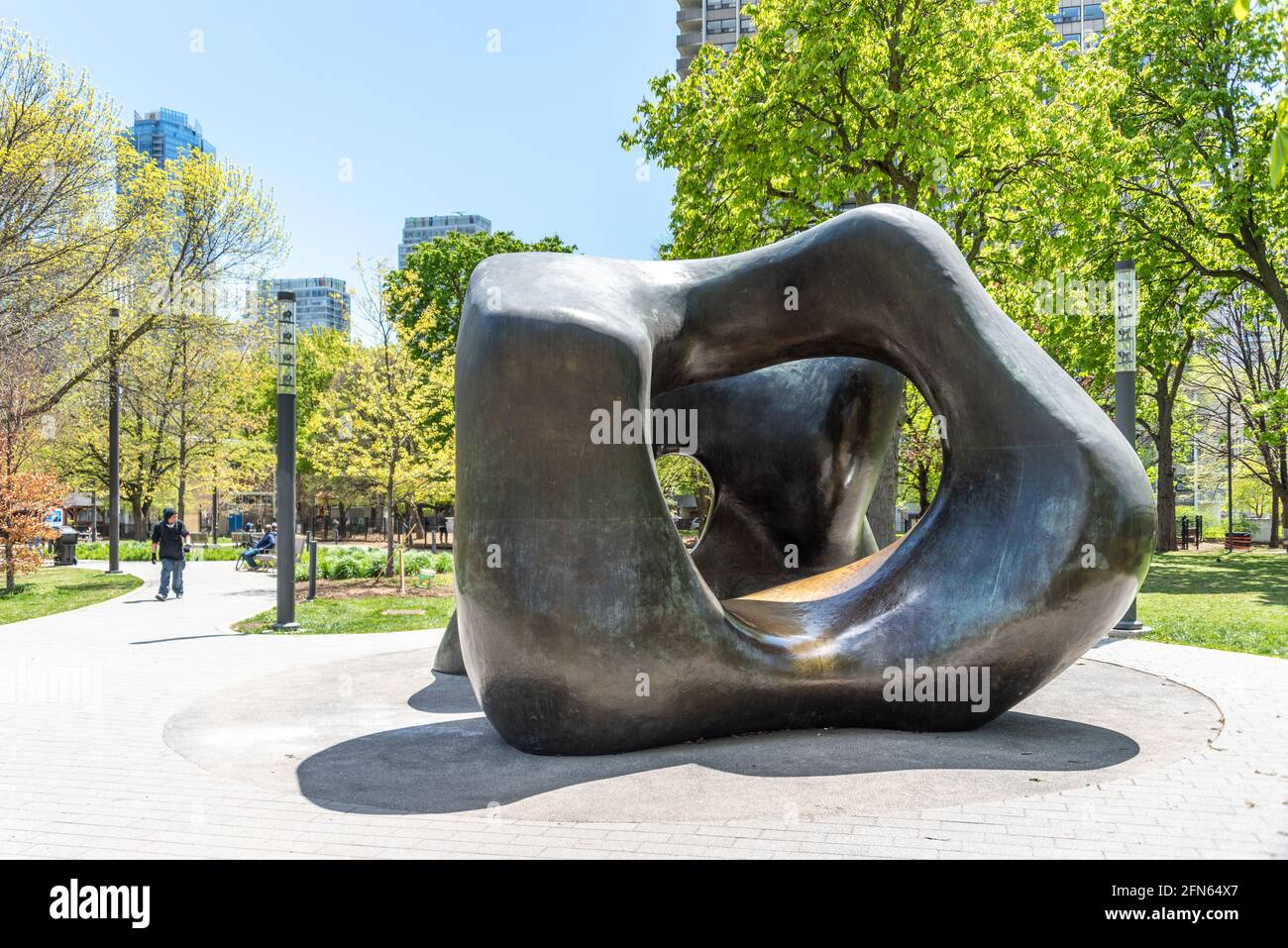 The sculpture is named 'Large Two Forms' by Henry Moore. It is located in The Grange Park behind the Art Gallery of Ontario (AGO) in Toronto, Canada Stock Photo